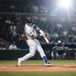 Boost Your OBP: 3 Key Batting Adjustments for Hitters Baseball player making a powerful swing to improve on-base percentage