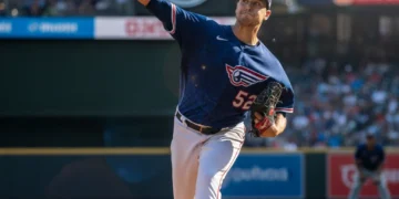 MLB pitcher on the mound, mid-delivery, illustrating recent rule changes.