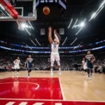 NBA 3-Point Revolution: Impact on Offenses This Season NBA player shooting a three-pointer in a dynamic game