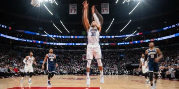 NBA player shooting a three-pointer in a dynamic game