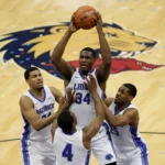 NBA Rebounding Efficiency: A Data-Driven Analysis NBA player securing a defensive rebound during a competitive game, surrounded by opponents.