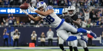 NFL wide receiver making a contested catch during a game